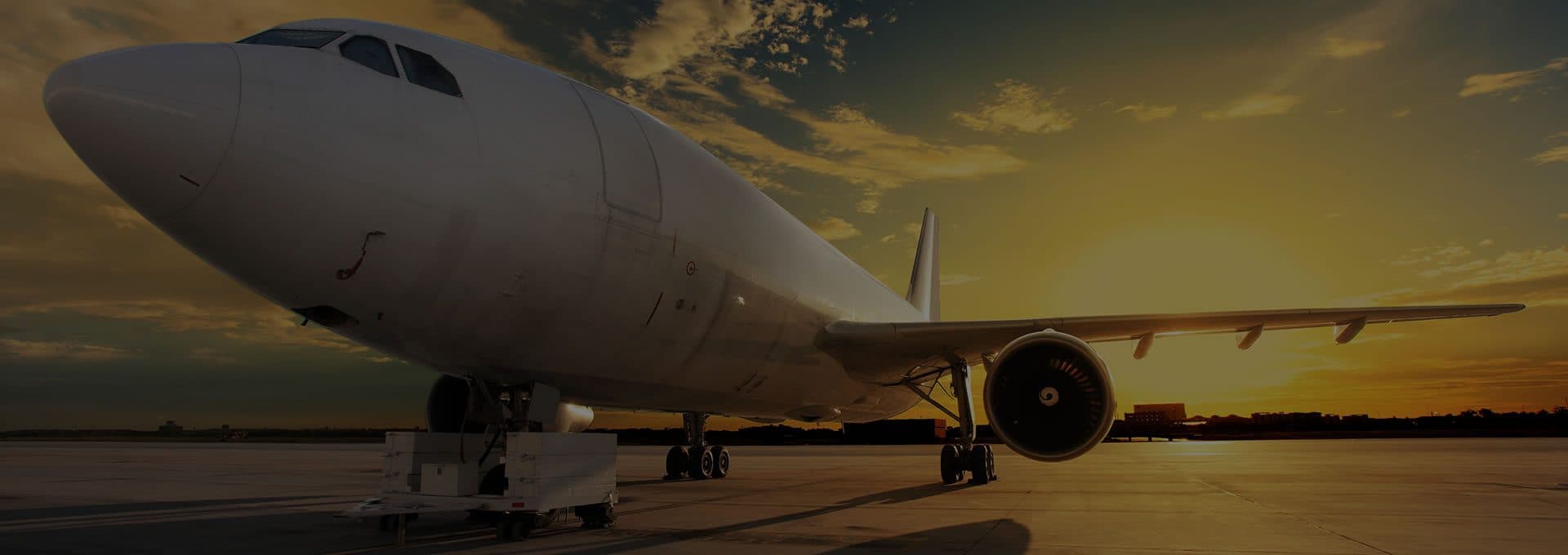 Cargo aircraft on the runway at sunset